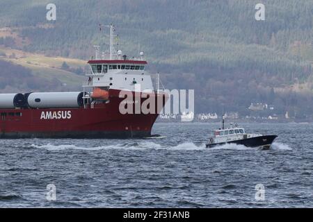 Jaguar, a general cargo vessel operated by Amasus Shipping, with the Clydeport pilot boat Mount Stuart, passing Gourock on the Firth of Clyde. Stock Photo