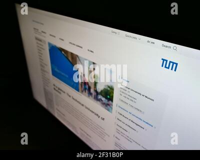 High angle view of web page with logo of German education institution Technical University of Munich on monitor. Focus on top-left of screen. Stock Photo