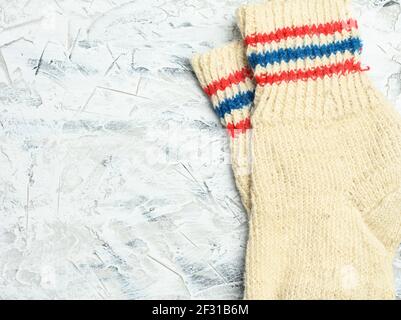 Pair of warm comfortable knitted socks on a white background Stock Photo