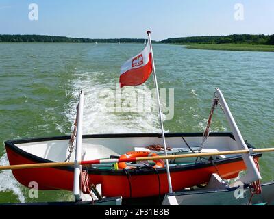 The Polish national flag on stern of a vessel on a lake in Masuria in Poland Stock Photo