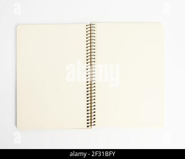 Open spiral notepad with blank white sheets on white background Stock Photo