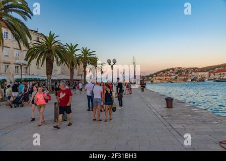 Trogir, Croatia, July 22, 2020: People are walking on seaside promenade during sunset in Trogir, Croatia Stock Photo