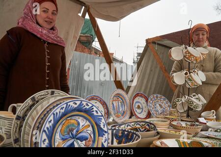A counter with hand-painted dishes from the 17th century seen during the Maslenitsa celebrations.Celebration of Maslenitsa in the Museum of Military History in the scenery of a real 17th century castle on the Krutitsky Patriarchal Compound in Moscow. Stock Photo