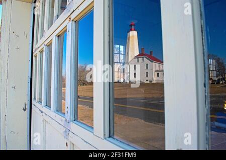 Sandy Hook Lighthouse reflected in the window pane of a nearby garage door -42 Stock Photo
