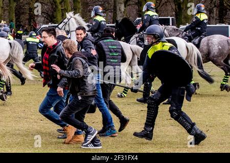 THE HAGUE, NETHERLANDS - MARCH 14: Police are seen charging protesters during a protest on the Malieveld against the coronavirus policies and the government on March 14, 2021 in The Hague, Netherlands ahead of the March 17 general elections. (Photo by Niels Wenstedt/BSR Agency/Alamy Live News) Stock Photo