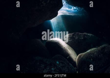 Underwater cave in ocean with sun rays Stock Photo