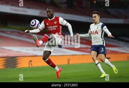 Arsenal's Nicolas Pepe (left) and Tottenham Hotspur's Sergio Reguilon in action during the Premier League match at Emirates Stadium, London. Picture date: Sunday March 14, 2021. Stock Photo