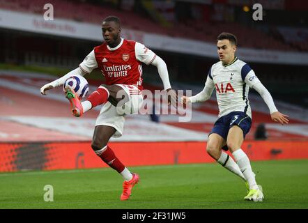 Arsenal's Nicolas Pepe (left) and Tottenham Hotspur's Sergio Reguilon in action during the Premier League match at Emirates Stadium, London. Picture date: Sunday March 14, 2021. Stock Photo