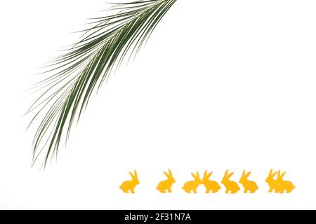 Palm Sunday concept. Two side border of palm tree branch and bunnies isolated on white background. Copy space. Stock Photo
