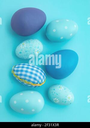 Happy Easter greeting card. Easter eggs collection blue pastel color on blue background, top view. Christian religion holiday celebration and decorati Stock Photo