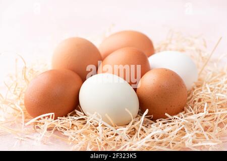 Chicken eggs on pink background closeup view. Easter eggs Stock Photo