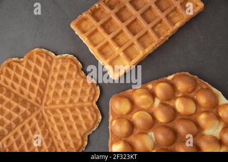 Three different waffles in square, flower and bubble shape. Stock Photo