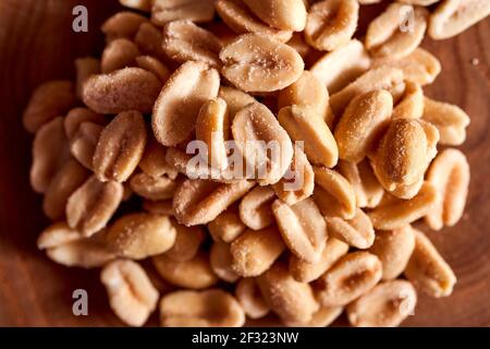 Salted peanuts on a wooden background. High quality photo Stock Photo