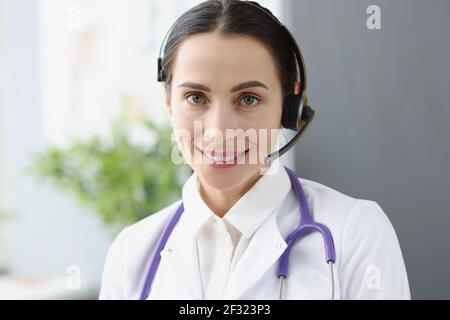 Portrait of doctor operator in headphones for remote work Stock Photo
