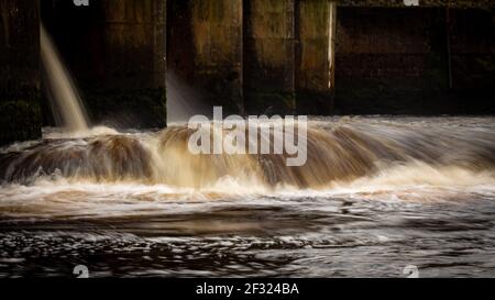 Water being released from the turbines at Kendoon Power Station on the Water of Ken, Galloway Hydro Electric Scheme, Scotland Stock Photo