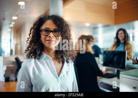 Portrait of a confident businesswoman standing in office. Mature woman working as an administrator in municipal office looking at camera. Stock Photo