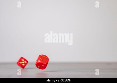 the die is cast, red dice falling on a gray wooden board Stock Photo