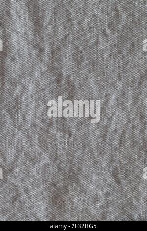 Top view on gray crumpled linen fabric background. Close-up of tea towel, napkin, tablecloth or clothing. Concept of simplicity, environmental friendl Stock Photo