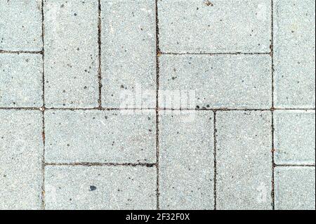 Granite tiles of various shapes, seamless textured pattern. The surface is tiled with rectangular mosaic tiles of various sizes. Stock Photo