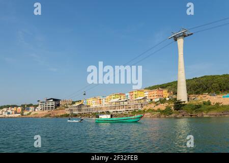 Fishing boat and cable car leaving the staion in the background, Phu Quoc island, Vietnam Stock Photo