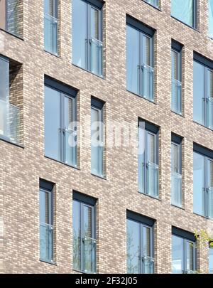 Modern architecture background. Rerctangular windows and clinker bricks fascade. Stock Photo