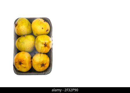 Sour apples on gray plastic tray packed on white isolated background Stock Photo