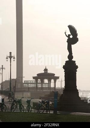 The Peace Statue of 1912 on the Brighton & Hove boundary. Brighton and Hove, England, UK. The Victorian bandstand, and i360 tower in the background. Stock Photo