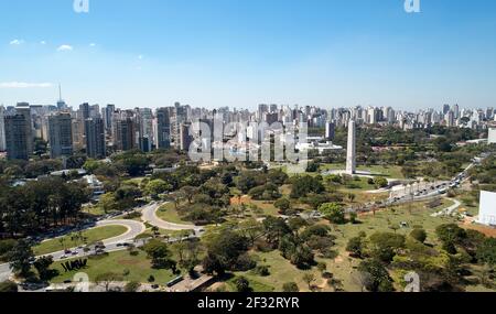 Aerial view of Ibirapuera park in Sao Paulo city, obelisk monument. Prevervetion area with trees and green area of Ibirapuera park. Office buildings a Stock Photo