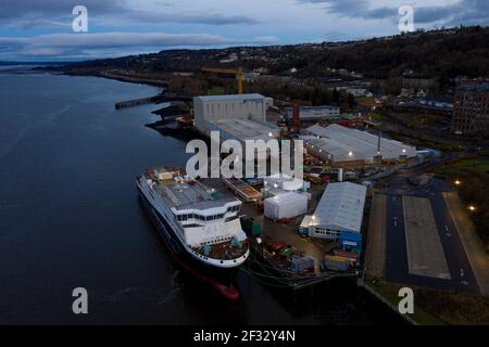 Port Glasgow, Scotland, UK. 14th Mar, 2021. Pictured: Drone photography aerial view of the Caledonian MacBrayne (CalMac) ferry named Glen Sannox, floats in the Firth of Clyde still currently under fabrication. The now Scottish Government owned project is well overdue but expected to be delivered to Caledonian MacBrayne sometime this coming year. COVID19 shutdowns have added an additional cost of £4.3m to the already over-budget ferry costs. Credit: Colin Fisher/Alamy Live News Stock Photo