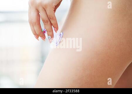 Woman getting anti-cellulite massage of hips with use of vacuum cans Stock Photo