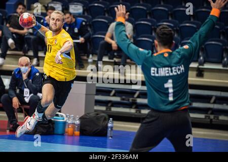 Vilnius. 14th Mar, 2021. Benas Petreikis (L) of Lithuania shoots during the Qualification Phase 2 of the 2022 Men's EHF EURO handball match between Lithuania and Israel in Vilnius, Lithuania on March 14, 2021. Credit: Alfredas Pliadis/Xinhua/Alamy Live News Stock Photo