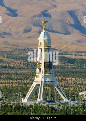 Neutrality Monument in Ashgabat, Turkmenistan built with white marble. Saparmurat Niyazov gold statue at the top. Arch of Neutrality. Stock Photo