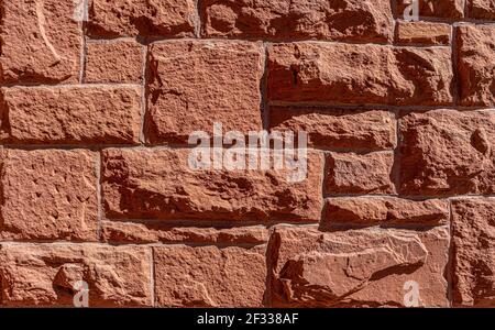 Red hand made brick wall background. Abstract pattern with inequalities. Close up view to red brick texture. Stock Photo
