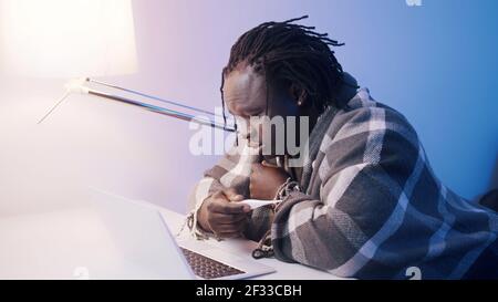 Ill african american black man with high fever having online consultation with doctor. Covid-19 positive person using laptop. High quality photo Stock Photo