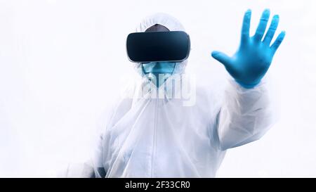 African american black doctor in protective uniform and with VR glasses. Futuristic surgery. High quality photo Stock Photo