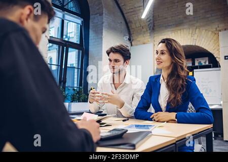 businesspeople discussing at table in office Stock Photo
