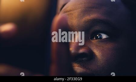 Close up Black man browsing news in shock. High quality photo Stock Photo