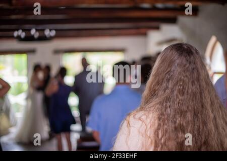 Selective focus on woman watching wedding ceremony Stock Photo
