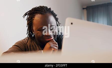 Young african man smiling while having video call. Online dating concept. High quality photo Stock Photo