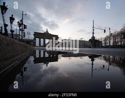 Berlin, Germany. 15th Mar, 2021. The Brandenburg Gate is reflected in a puddle of rain. Credit: Paul Zinken/dpa-Zentralbild/dpa/Alamy Live News Stock Photo