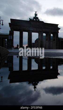 Berlin, Germany. 15th Mar, 2021. The Brandenburg Gate is reflected in a puddle of rain. Credit: Paul Zinken/dpa-Zentralbild/dpa/Alamy Live News Stock Photo