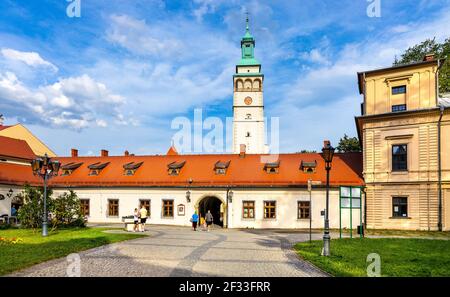 Zywiec, Poland - August 30, 2020: Main gate to Palace of Habsburgs, Old Castle and Zywiec Castle Park with Cathedral tower in historic city center
