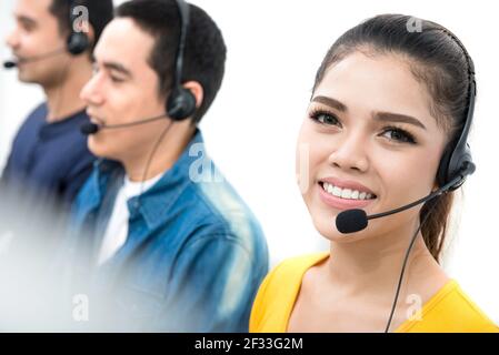 Smiling call center (or telemarketing) staffs Stock Photo