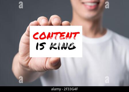 CONTENT IS KING, message on the card shown by a man Stock Photo