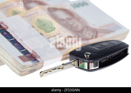 Close up car key and stacks of money thai baht Stock Photo