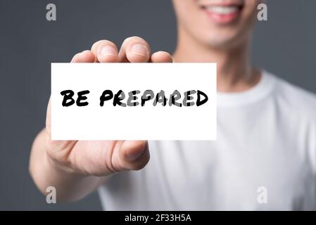 BE PREPARED, message on the card shown by a man Stock Photo