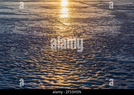 Sun reflection on the ice . Winter Sunset in the Village. Stock Photo