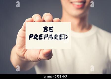 BE PREPARED, message on the card shown by a man, vintage tone effect Stock Photo