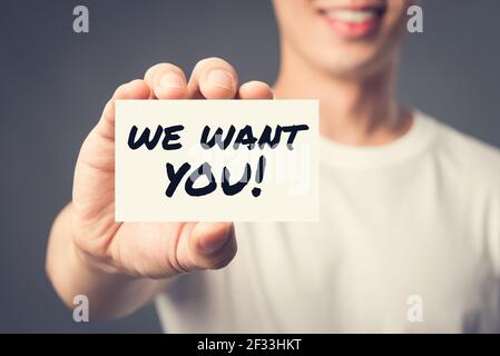 WE WANT YOU! message on the card shown by a man, vintage tone effect Stock Photo