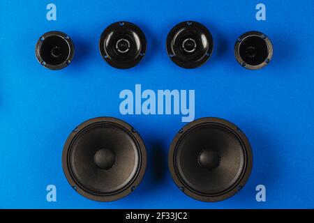 Car audio, car speakers, black subwoofer on a blue background. Stock Photo